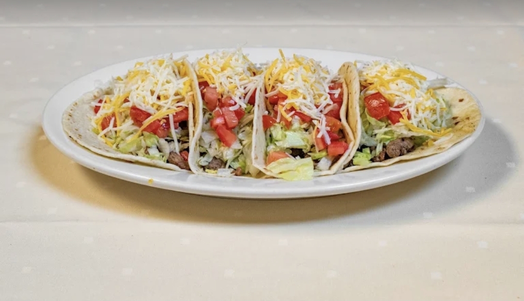 American hard shell tacos with lettuce, tomato and cheese