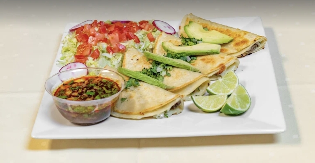Quesadilla Supreme plated with salsa and salad